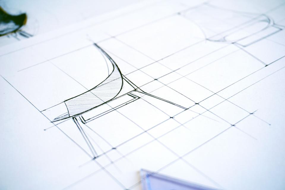 Architectural design plans and drawings on a desk